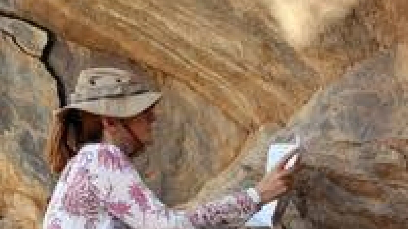 woman etching rock
