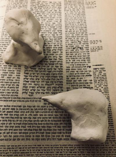 2 raven sculptures against Hebrew text