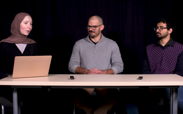 three students sitting at a table