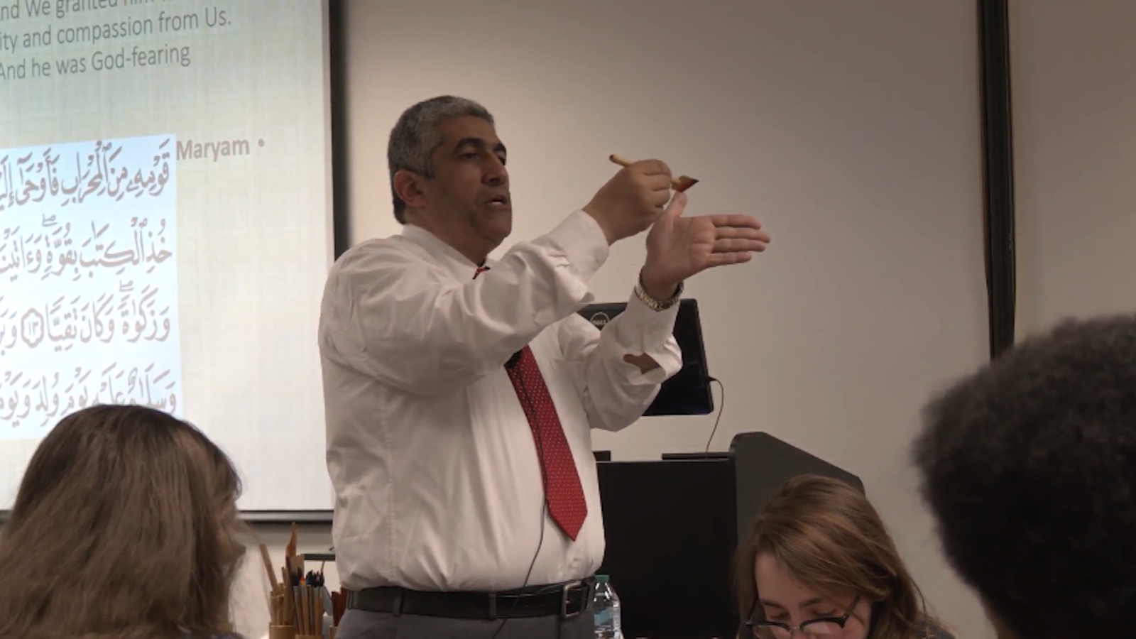 Dr. Habib holding calligraphy brush